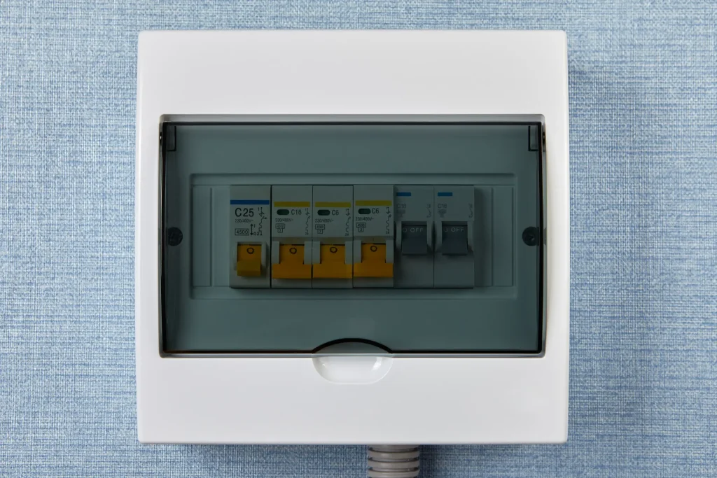 Consumer unit with labelled circuit breakers rated at C25, C16, and C6 behind a clear cover