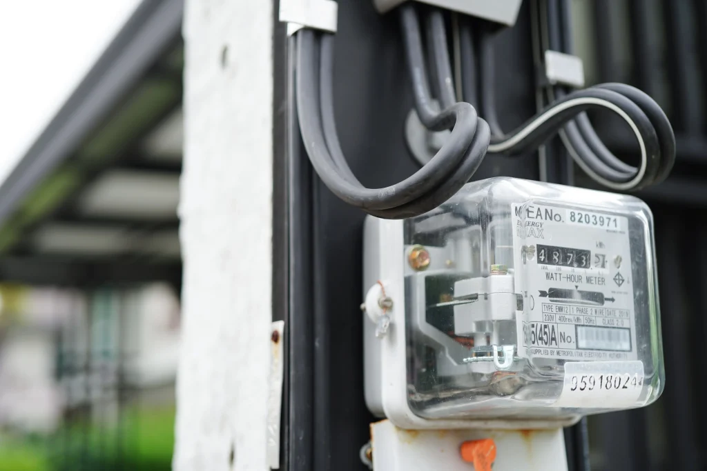 Close-up of a single-phase watt-hour electricity meter mounted on an exterior wall